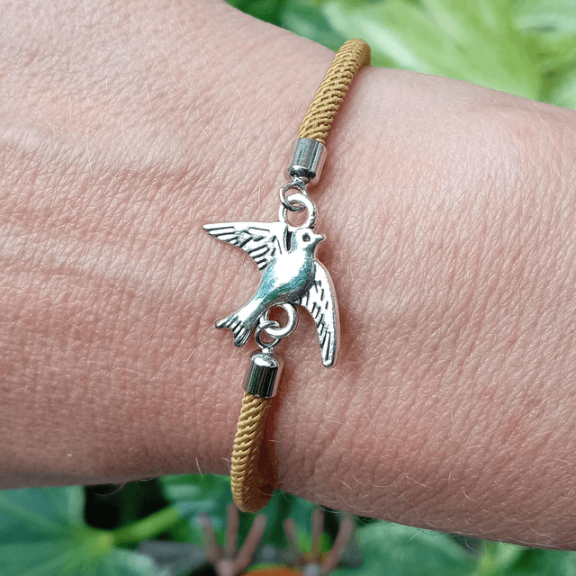 Gold kids bracelet with a Bird Charm